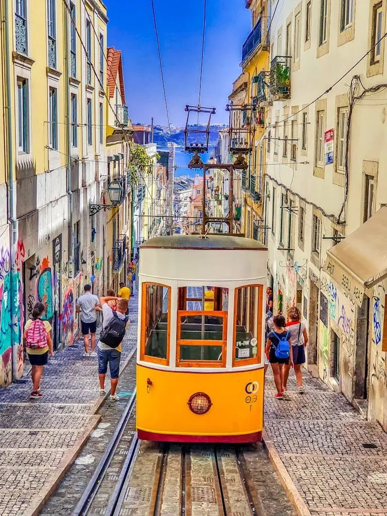 People Walking on Street Near Yellow Tram