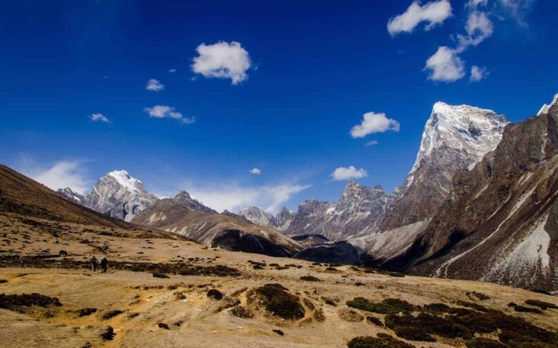 The Nepal lanscape in mountainous and snow covered in the distance.