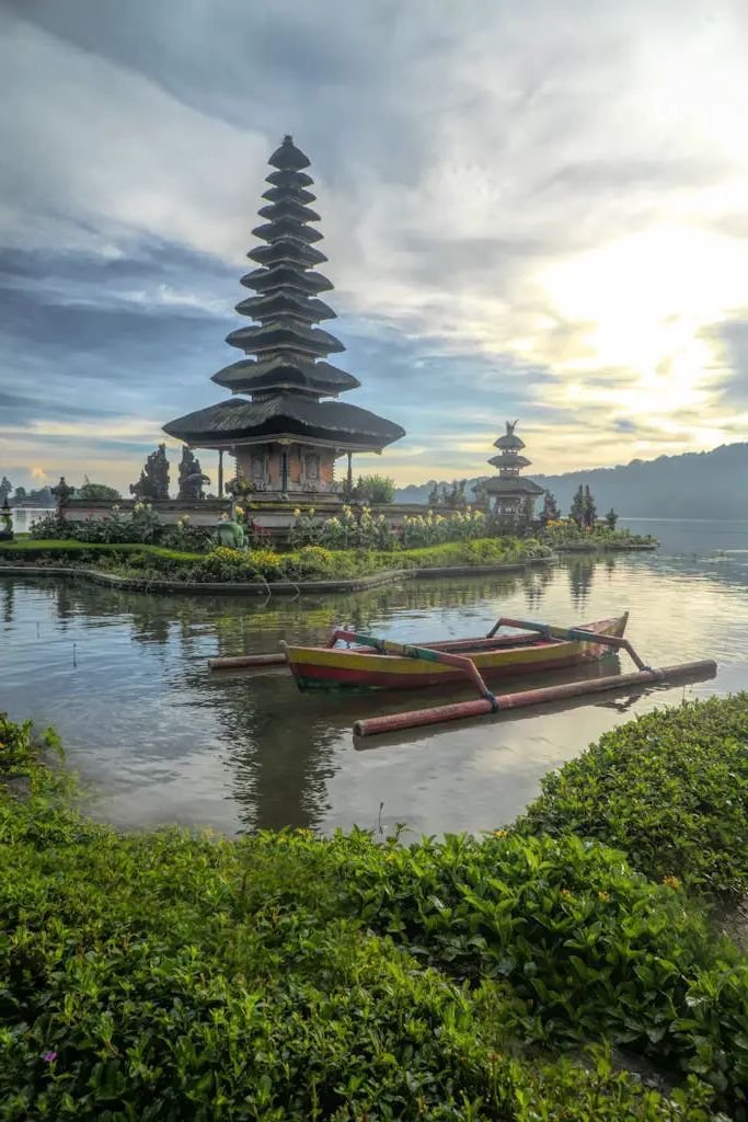 Canoe on Body of Water With Pagoda Background