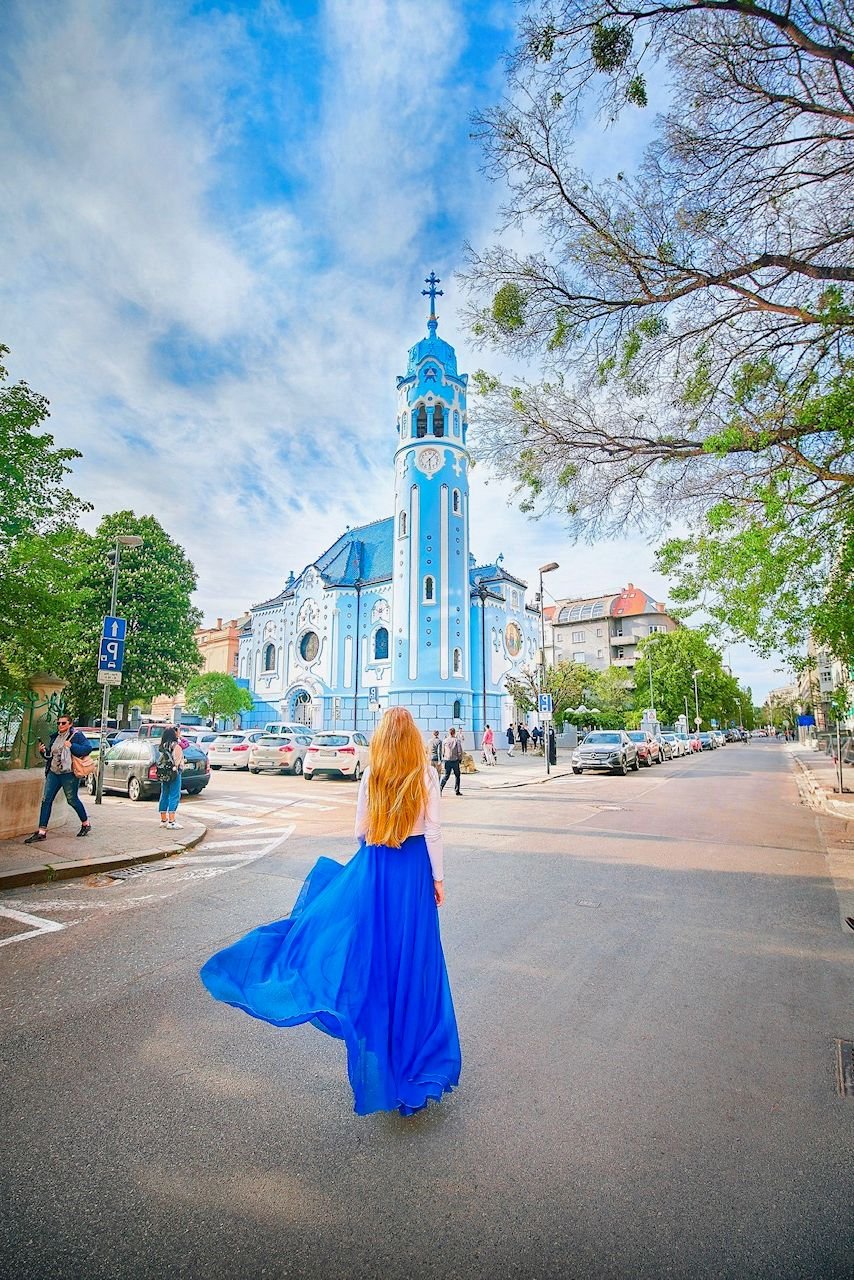Hidden Gems in Europe Church of St. Elizabeth with girl in blue dress in fornt.