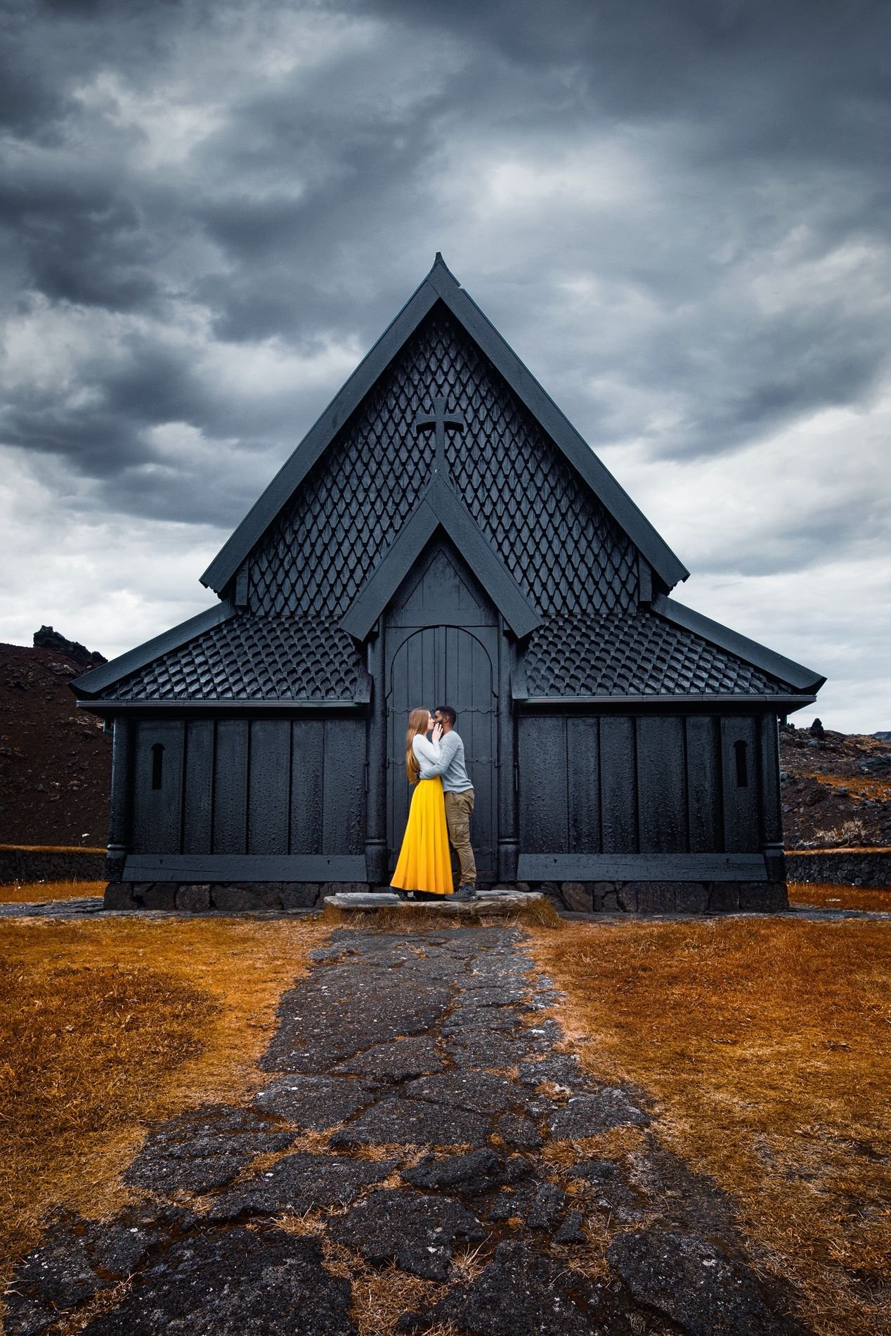 Hidden Gems in Europe Heimaey Stave Church with young couple in front