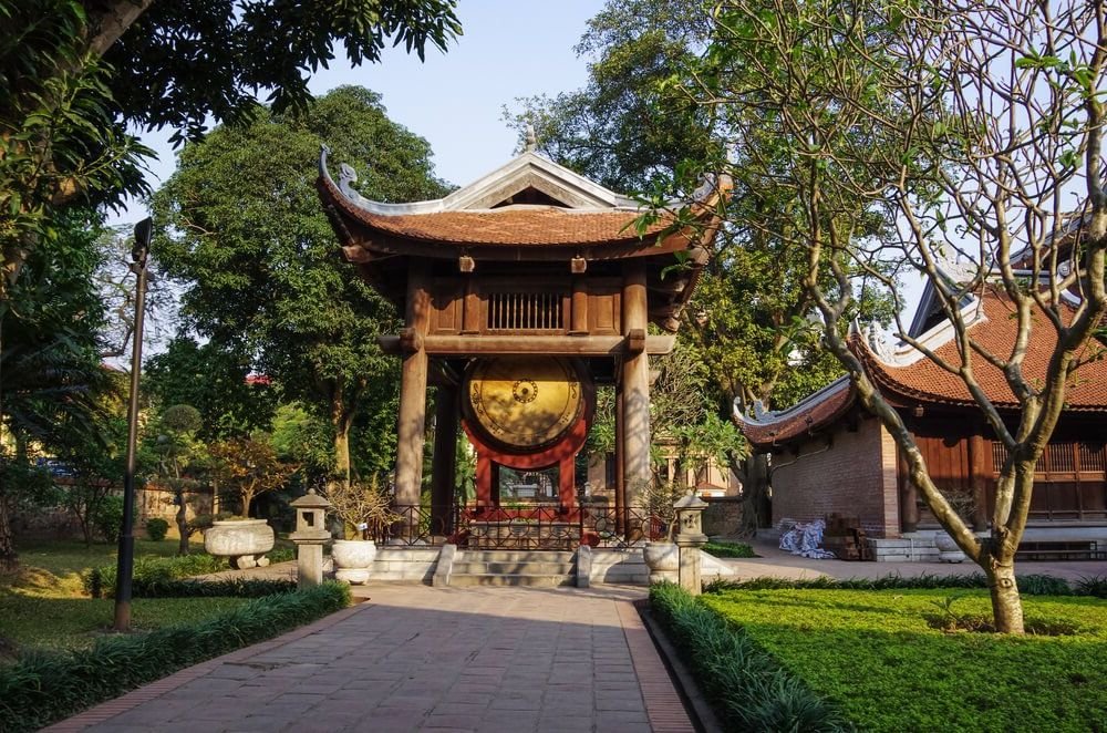 the temple of literature in hanoi with a pagoda and gold circle insignia