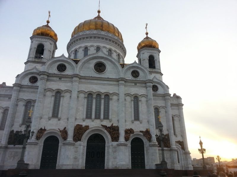 Gold domes on the church in Russia with white marble