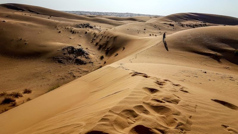 Dan walking on a dune in Oman as seen from afar