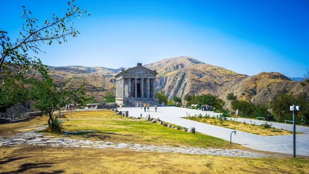 temple of garni in armenia with beautiful landscape of armenian countryside behind it